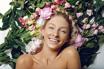 Image showing Beautiful girl lying in flowers