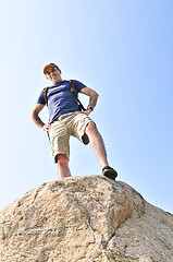 Image showing Hiker standing on a rock