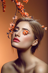 Image showing Beautiful girl with sakura branch