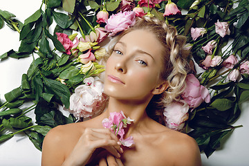 Image showing Beautiful girl lying in flowers