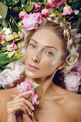 Image showing Beautiful girl lying in flowers