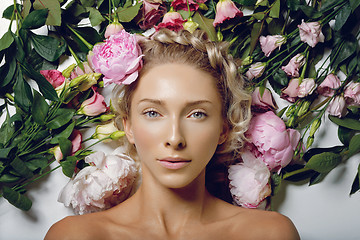 Image showing Beautiful girl lying in flowers