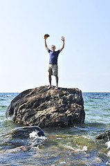 Image showing Man stranded on a rock in ocean