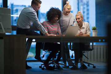 Image showing Multiethnic startup business team in night office