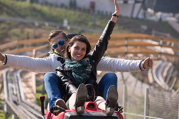 Image showing couple enjoys driving on alpine coaster