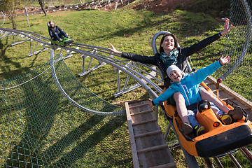 Image showing mother and son enjoys driving on alpine coaster