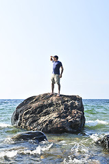 Image showing Man stranded on a rock in ocean