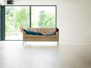 Image showing Man using laptop in living room