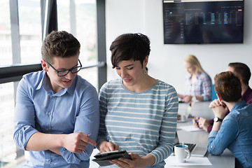 Image showing Two Business People Working With Tablet in office