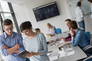 Image showing Two Business People Working With Tablet in office