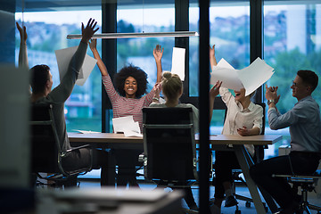 Image showing multiethnic Group of young business people throwing documents