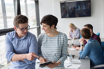 Image showing Two Business People Working With Tablet in office