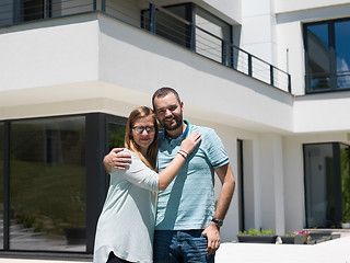 Image showing couple hugging in front of  new luxury home