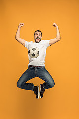 Image showing The young man as soccer football player kicking the ball at studio