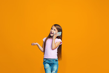 Image showing The happy teen girl standing and smiling with phone