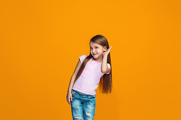 Image showing The young teen girl whispering a secret behind her hand