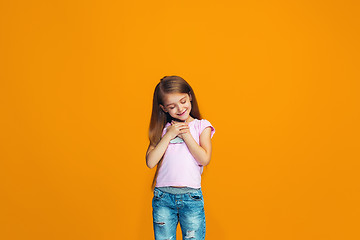 Image showing The happy teen girl standing and smiling with phone