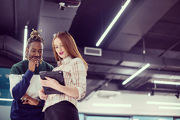 Image showing multiethnic business couple using a tablet computer