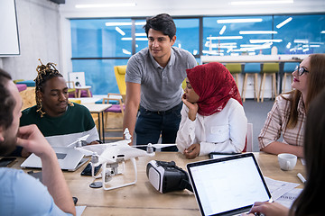 Image showing multiethnic business team learning about drone technology