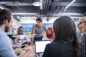 Image showing multiethnic business team learning about drone technology