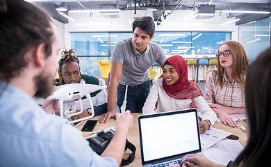 Image showing multiethnic business team learning about drone technology