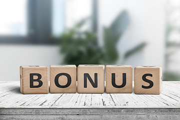 Image showing Bonus reward sign on a white table in a bright office 