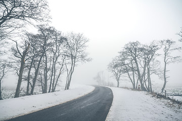 Image showing Highway curvy road in a misty winter scenery