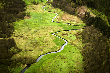 Image showing Small river going through a green area with fields