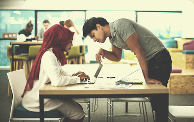 Image showing black muslim business woman having a meeting with her indian mal