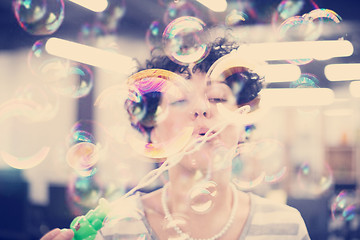 Image showing software developer having fun while making soap bubble