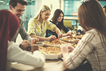 Image showing multiethnic business team eating pizza