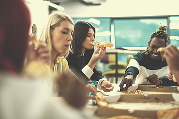 Image showing multiethnic business team eating pizza