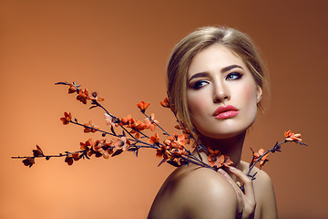 Image showing Beautiful girl with sakura branch