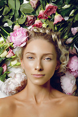 Image showing Beautiful girl lying in flowers