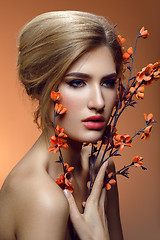 Image showing Beautiful girl with sakura branch