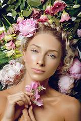 Image showing Beautiful girl lying in flowers