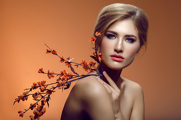 Image showing Beautiful girl with sakura branch