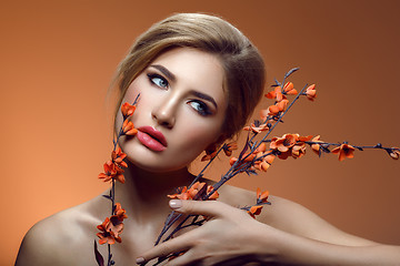 Image showing Beautiful girl with sakura branch