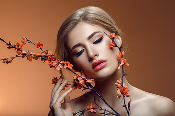 Image showing Beautiful girl with sakura branch