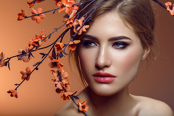 Image showing Beautiful girl with sakura branch