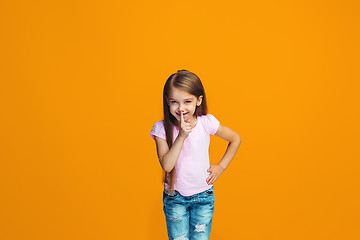 Image showing The young teen girl whispering a secret behind her hand