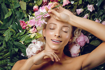 Image showing Beautiful girl lying in flowers