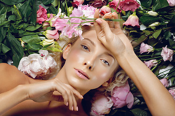 Image showing Beautiful girl lying in flowers