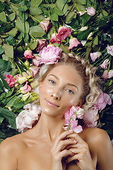 Image showing Beautiful girl lying in flowers