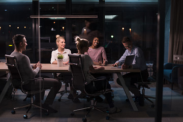 Image showing Multiethnic startup business team in night office