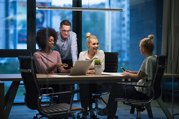 Image showing Multiethnic startup business team in night office