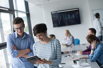 Image showing Two Business People Working With Tablet in office