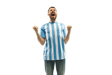 Image showing The Argentinean soccer fan celebrating on white background