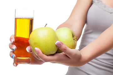 Image showing Beautiful girl hands with apple and glass of juice