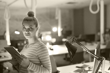 Image showing woman working on digital tablet in night office